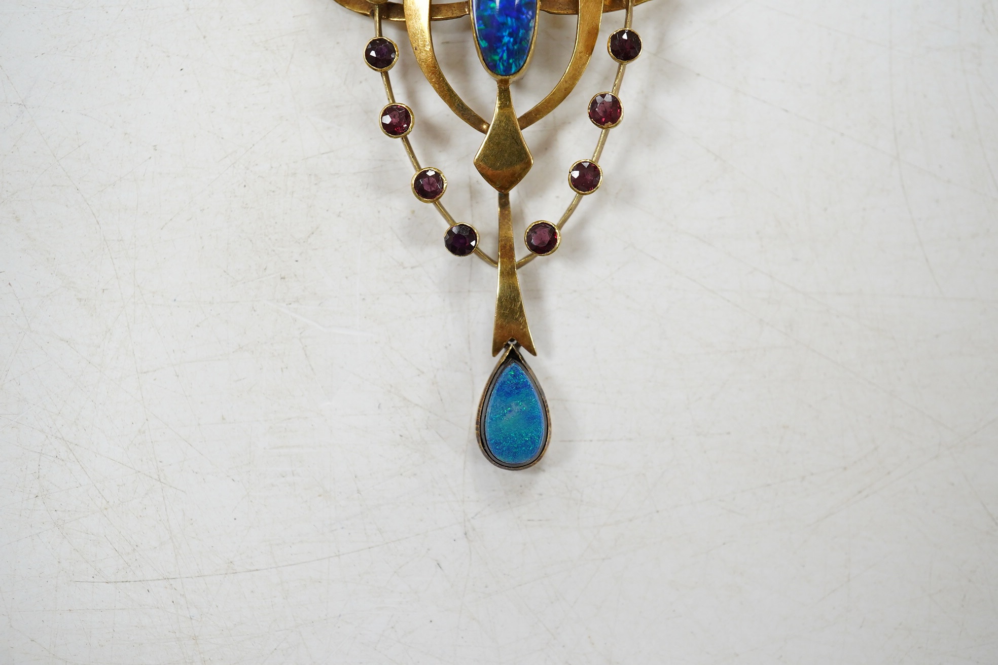 An Edwardian Art Nouveau 15ct, black opal doublet and ruby cluster set drop pendant, 55mm, gross weight 3.9 grams. Condition - fair to good